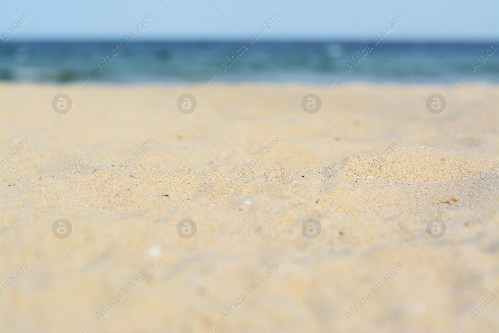 Photo of Beautiful sandy beach near sea, closeup view