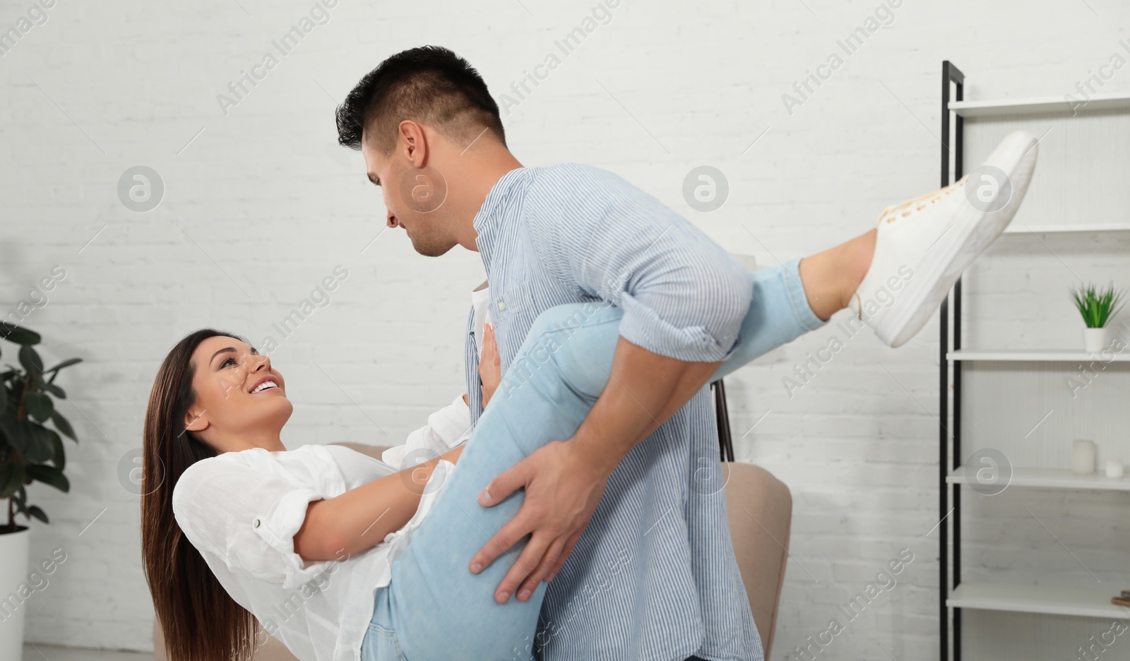 Photo of Happy couple dancing in living room at home