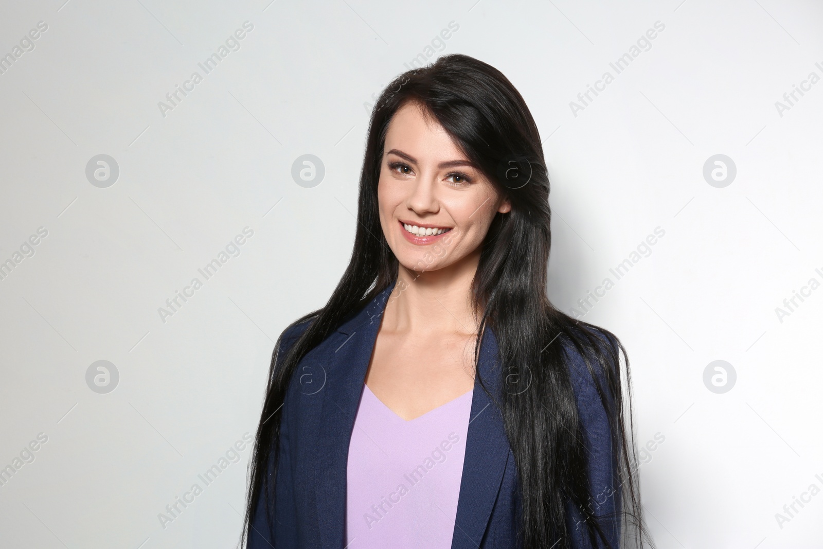 Photo of Portrait of stylish businesswoman on light background
