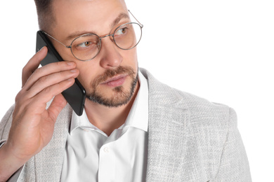 Businessman in glasses talking on smartphone against white background, closeup