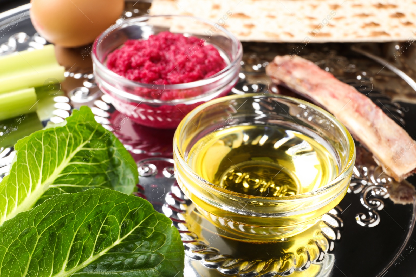 Photo of Closeup view of Passover Seder plate (keara) with traditional meal. Pesah celebration