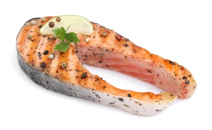 Tasty salmon steak with lemon, peppercorns and parsley isolated on white
