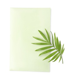 Scented sachet and green leaf on white background, top view