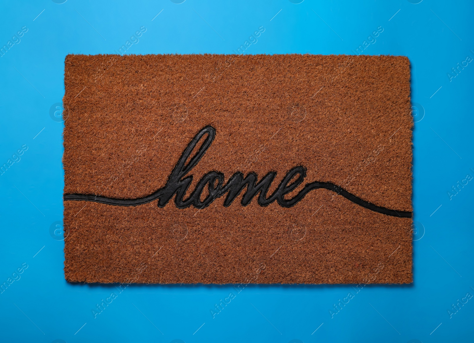 Photo of Doormat with word Home on light blue background, top view