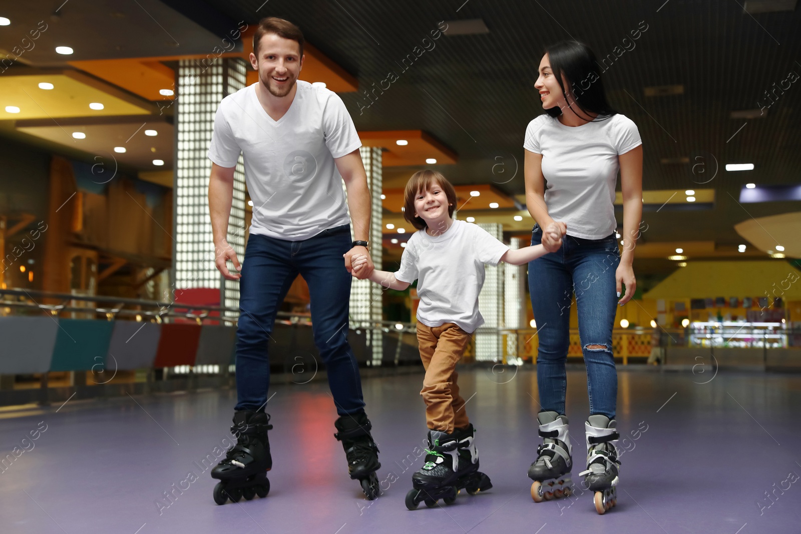 Photo of Happy family spending time at roller skating rink