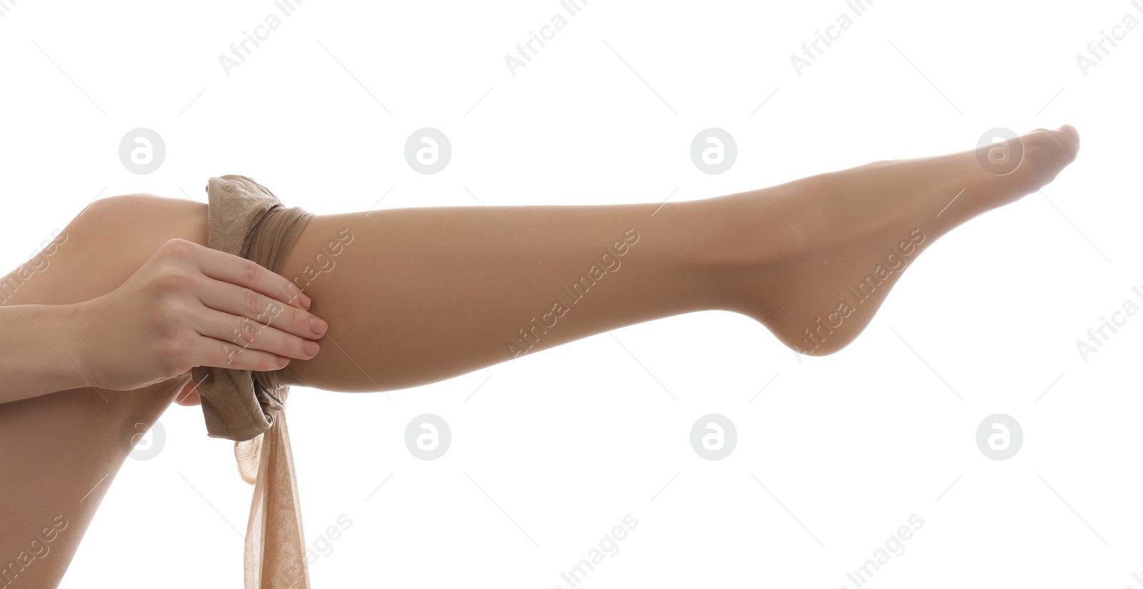 Photo of Young woman putting on tights against white background, closeup