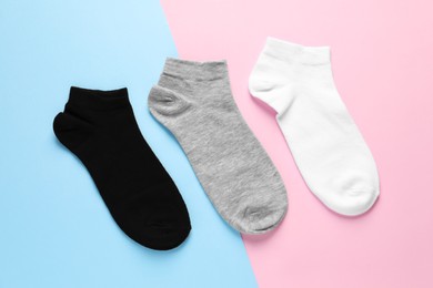 Photo of Different socks on colorful background, flat lay