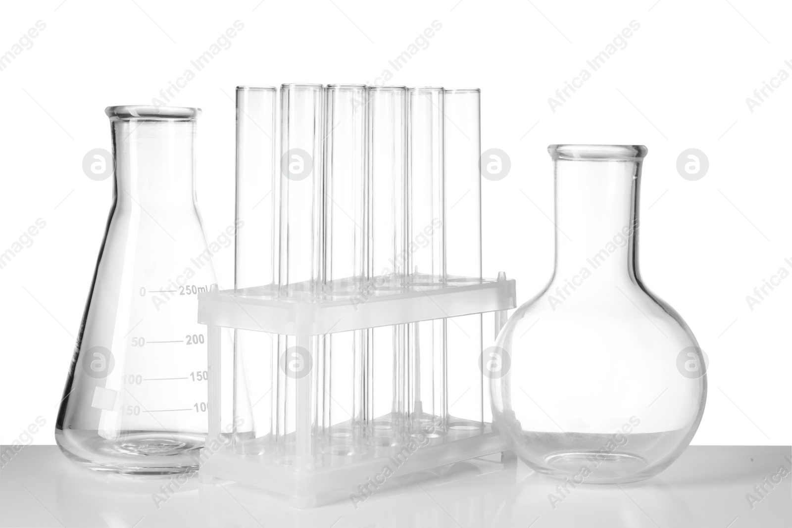 Photo of Empty laboratory flasks and test tubes isolated on white