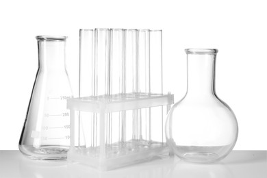 Photo of Empty laboratory flasks and test tubes isolated on white