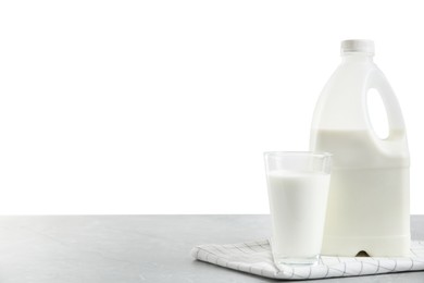 Photo of Gallon bottle of milk and glass on light grey table. Space for text. Space for text
