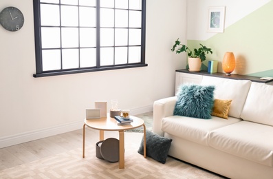 Photo of Stylish living room interior with comfortable sofa and table