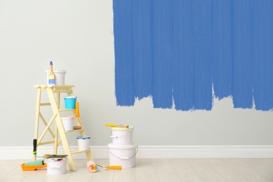 Image of Decorator's kit of tools and paints near wall indoors