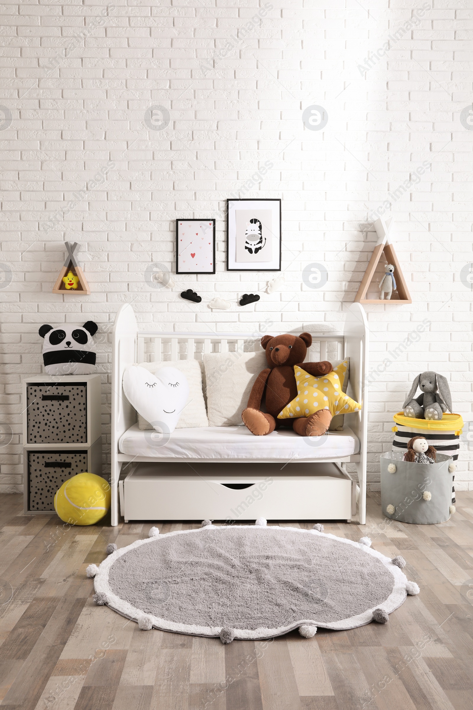 Photo of Cozy room with stylish furniture and toys for baby. Interior design