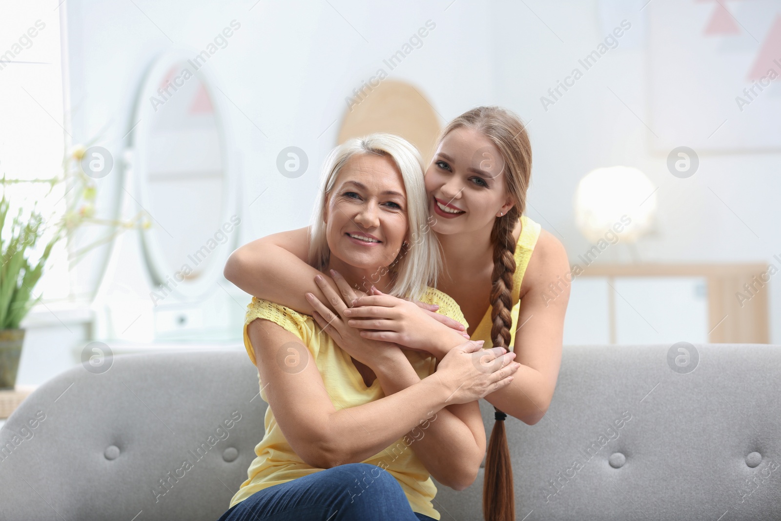 Photo of Mother and her adult daughter spending time together at home