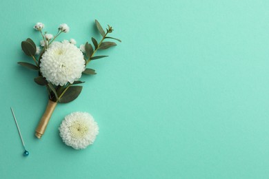 Small stylish boutonniere on turquoise background, top view. Space for text