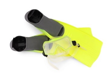 Pair of yellow flippers and diving mask isolated on white, top view. Sports equipment