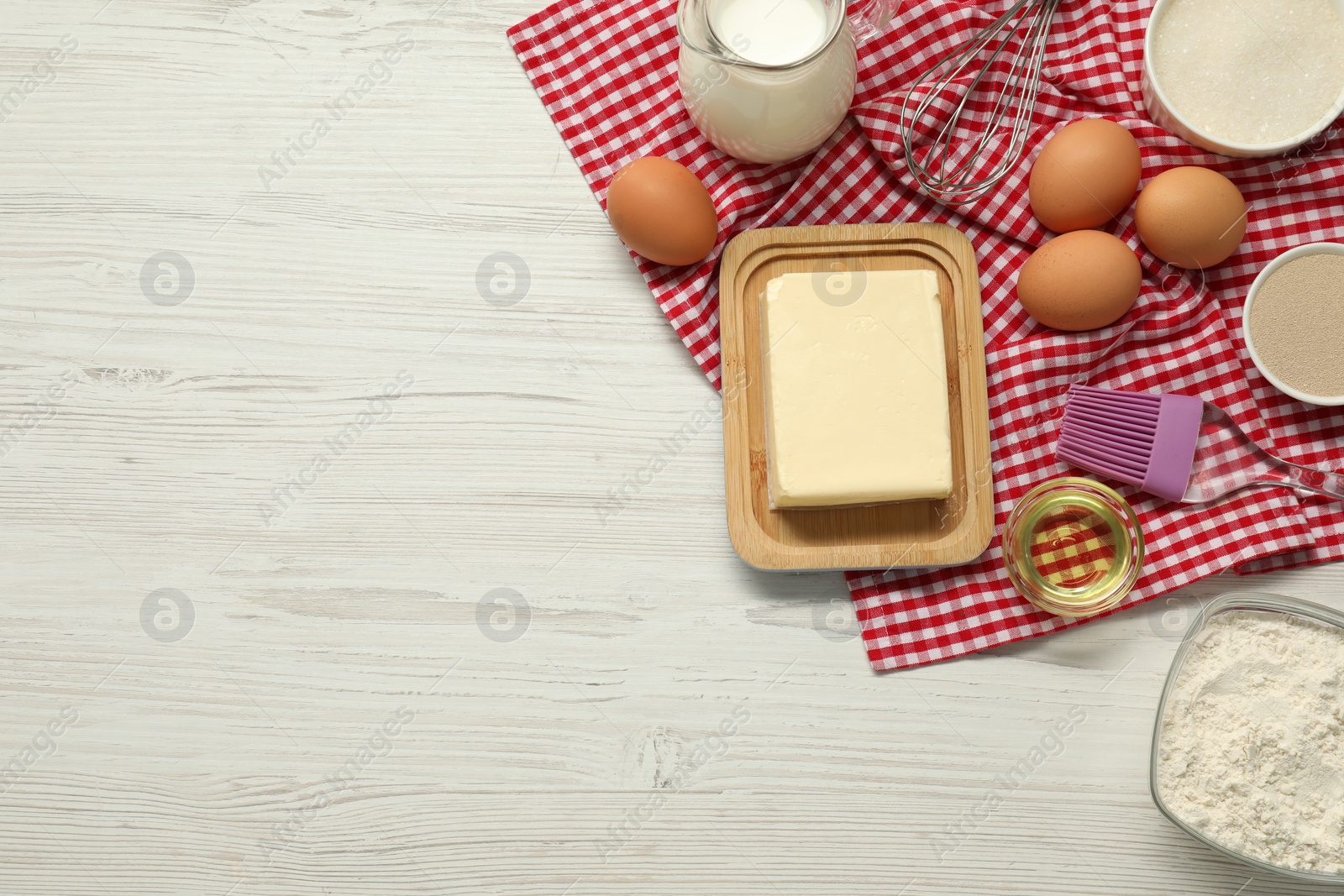 Photo of Flat lay composition with fresh butter and other products on light wooden table. Space for text