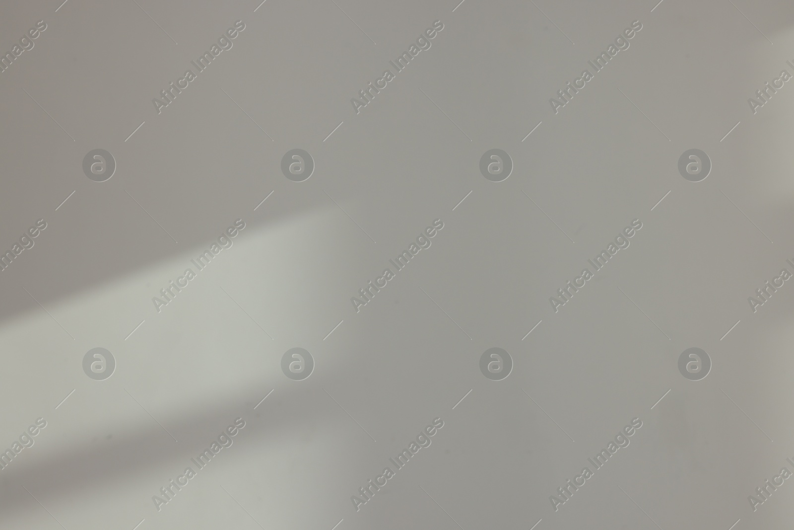 Photo of Light and shadows from window on wall indoors