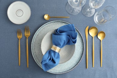 Photo of Stylish setting with cutlery, plates, napkin and glasses on table, flat lay