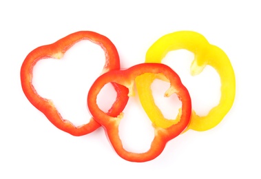 Rings of ripe bell peppers on white background, top view