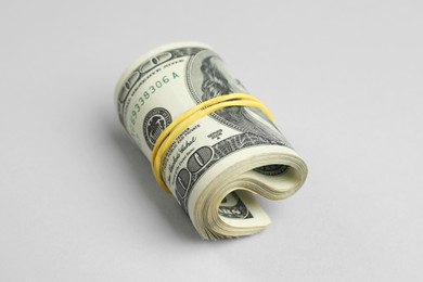 Photo of Money exchange. Rolled dollar banknotes on gray background, closeup