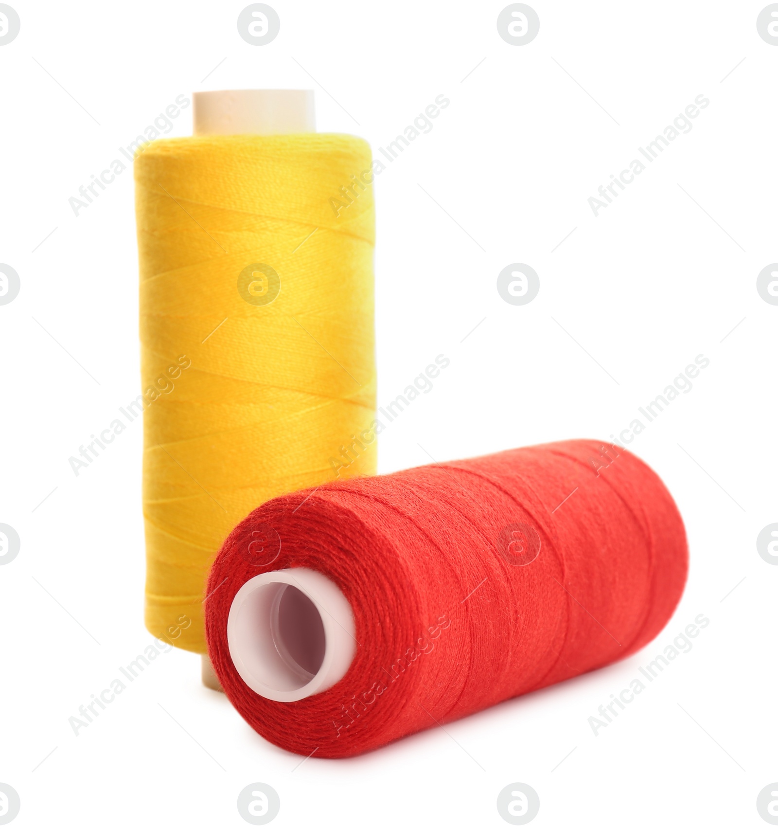 Photo of Different colorful sewing threads on white background