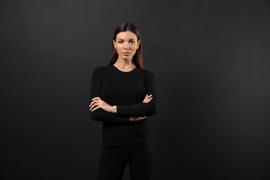 Photo of Woman wearing thermal underwear on black background