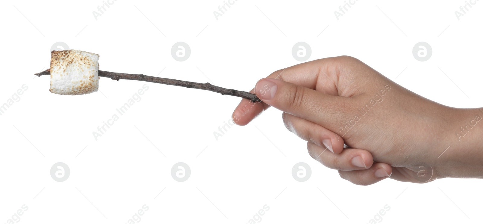 Photo of Woman holding twig with roasted marshmallow on white background, closeup