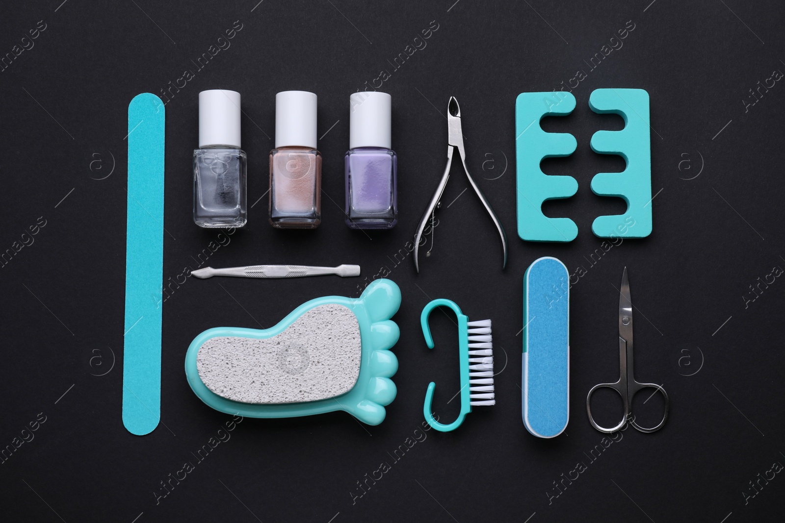Photo of Set of pedicure tools on black background, flat lay