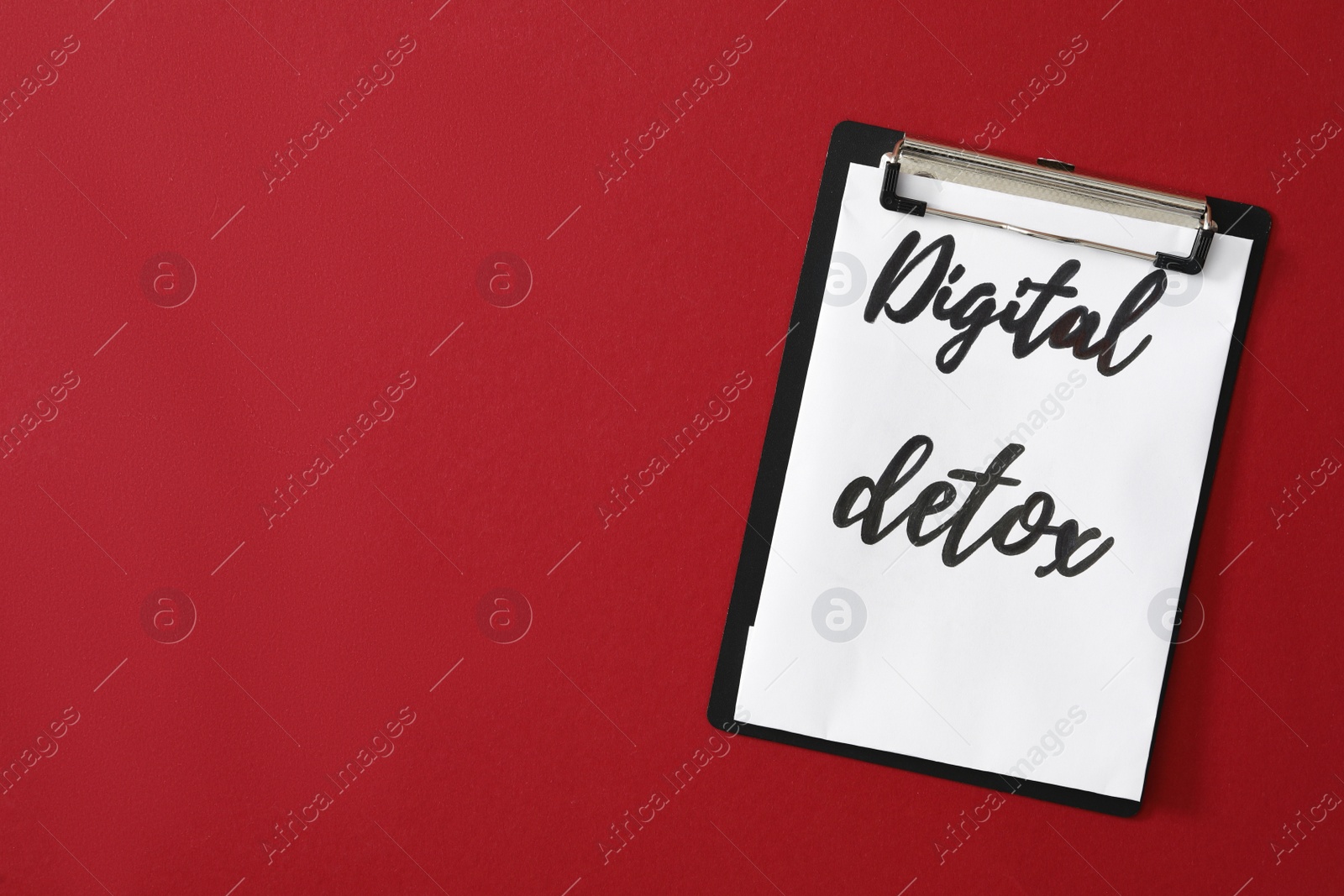 Photo of Clipboard with words DIGITAL DETOX on red background, top view. Space for text