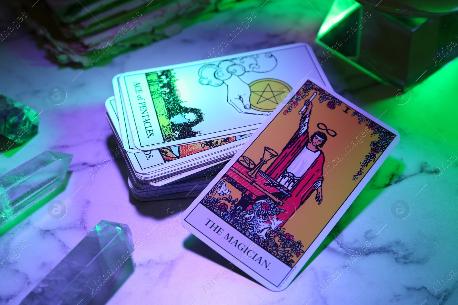 Photo of Magician and other tarot cards on marble table, color toned