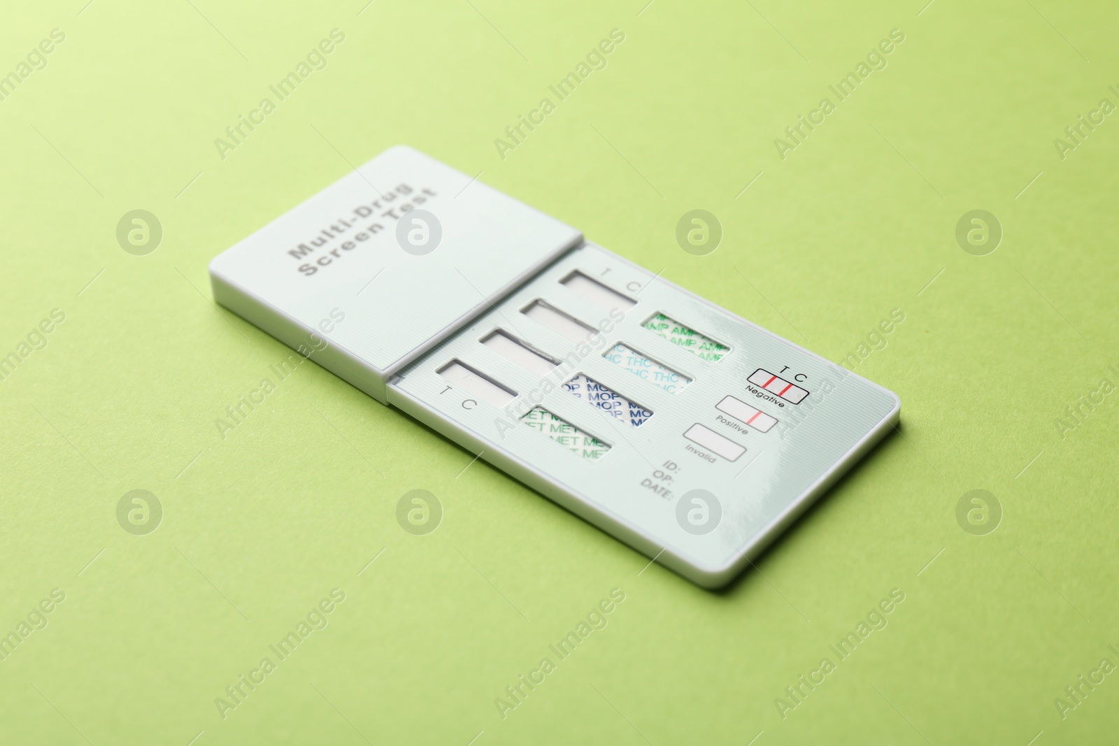 Photo of Multi-drug screen test on light green background, closeup