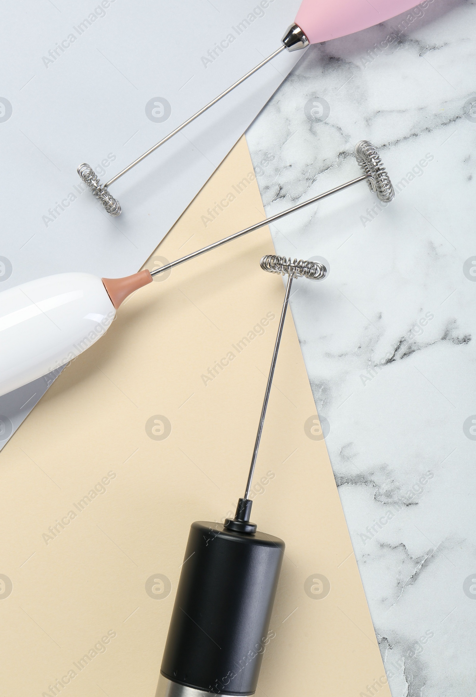 Photo of Milk frother wands on color background, flat lay