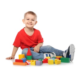 Little child playing with colorful building blocks on white background