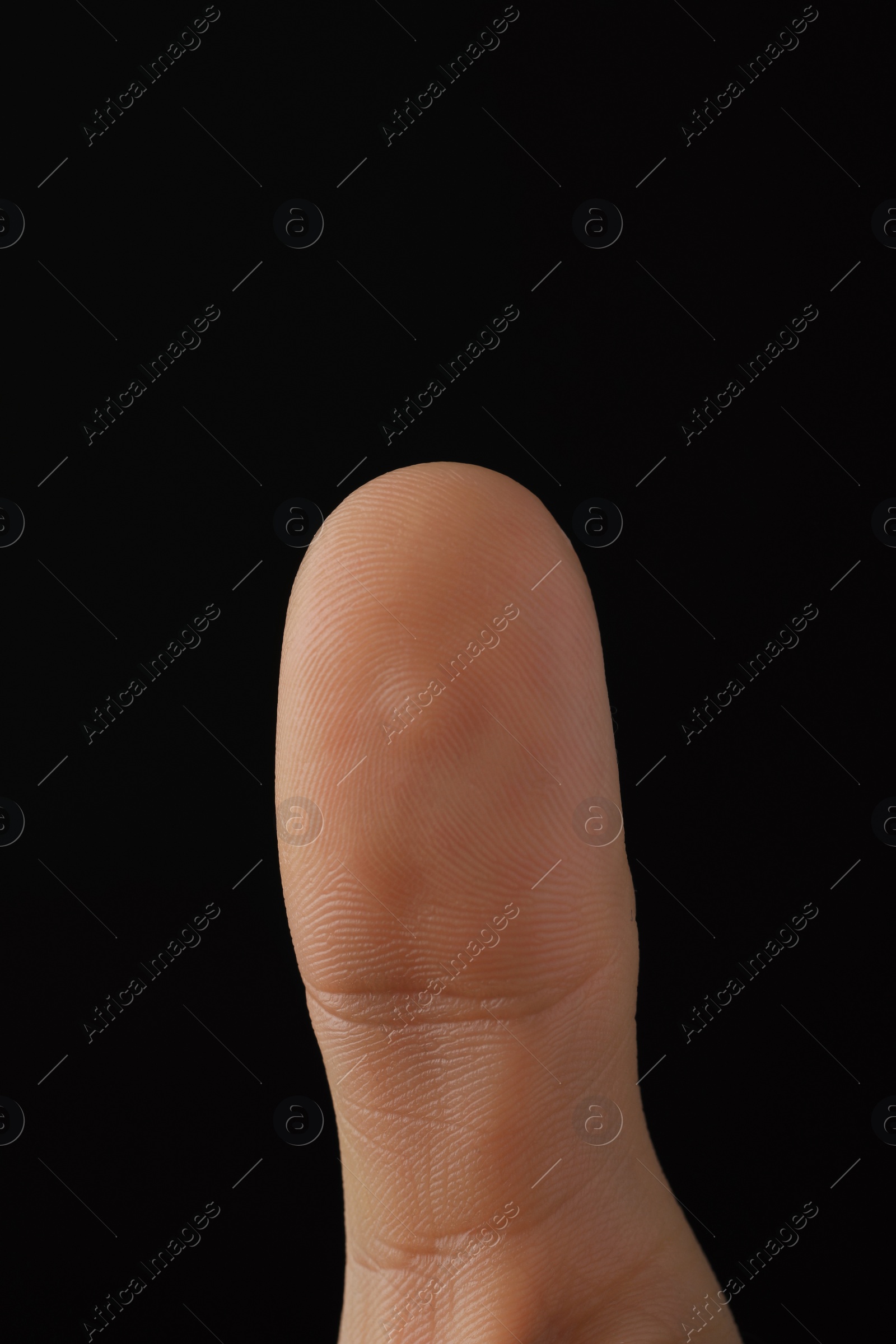 Photo of Man scanning fingerprint on black background, closeup