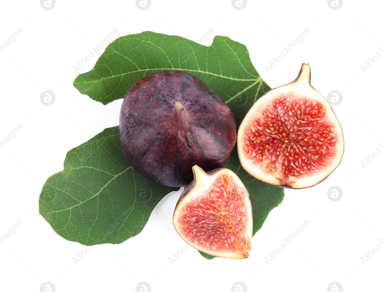 Photo of Fresh juicy purple figs and green leaves on white background, top view