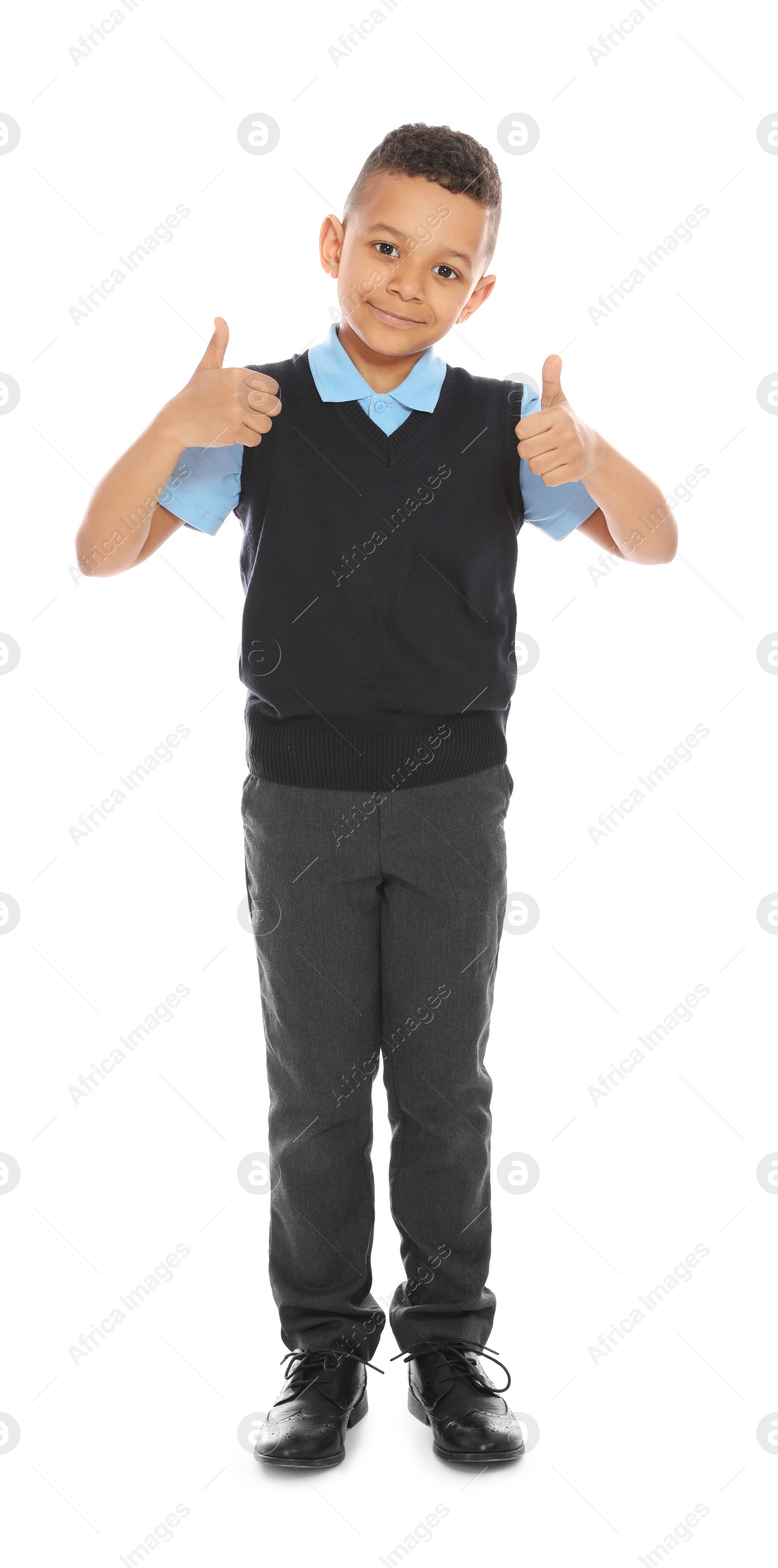 Photo of Full length portrait of cute African-American boy in school uniform on white background