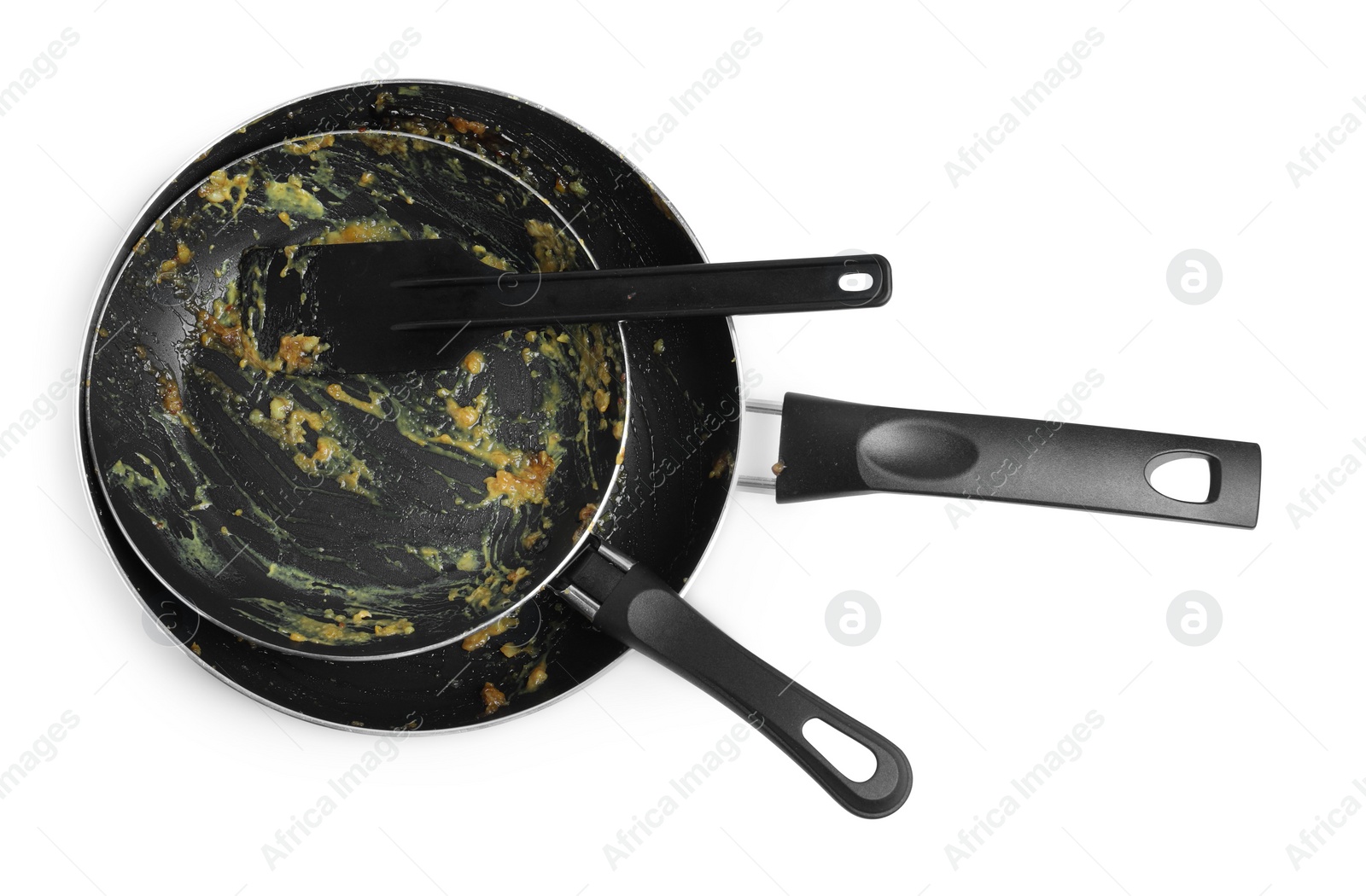 Photo of Dirty frying pans and spatula on white background