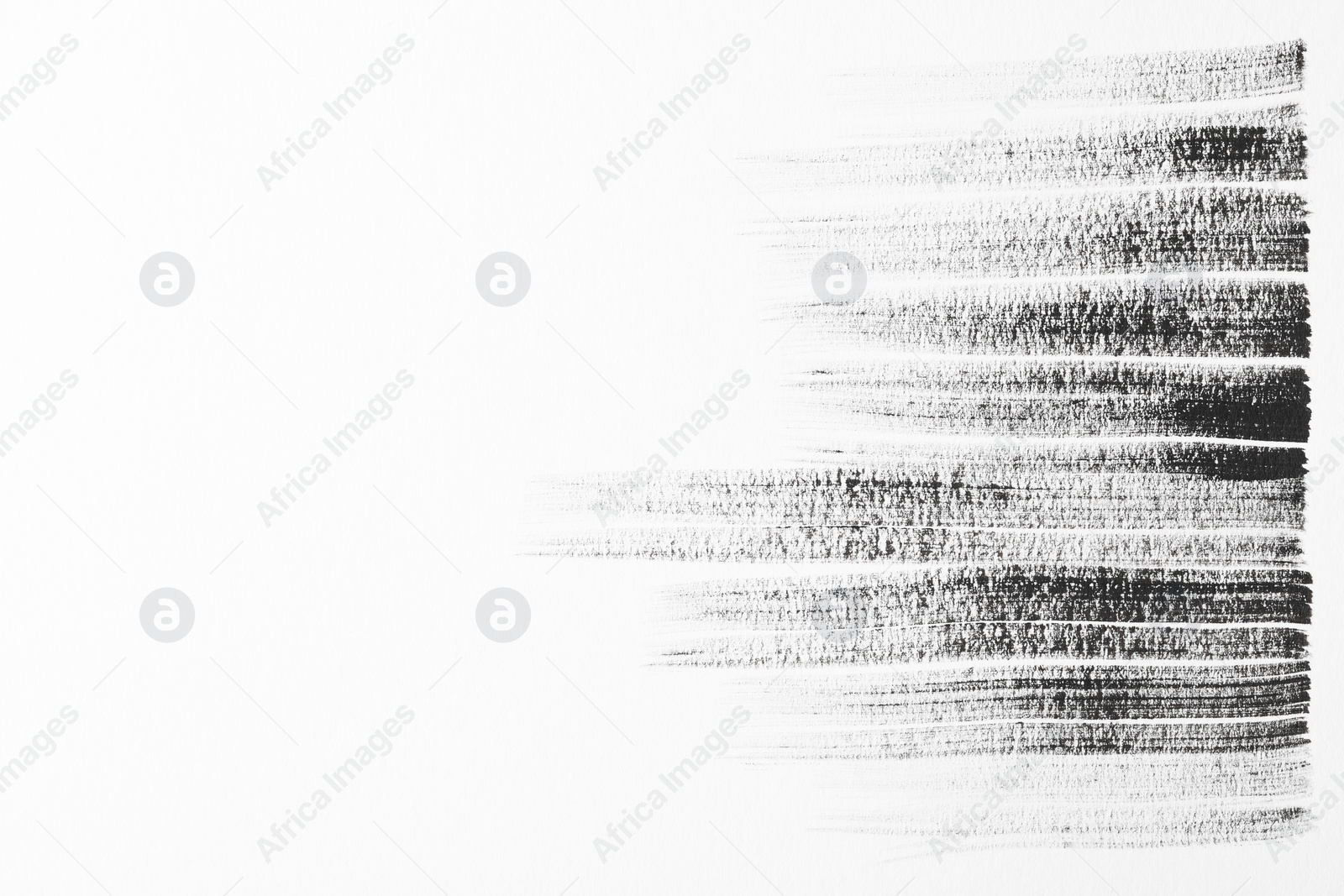 Photo of Strokes of black ink on white background, top view. Space for text