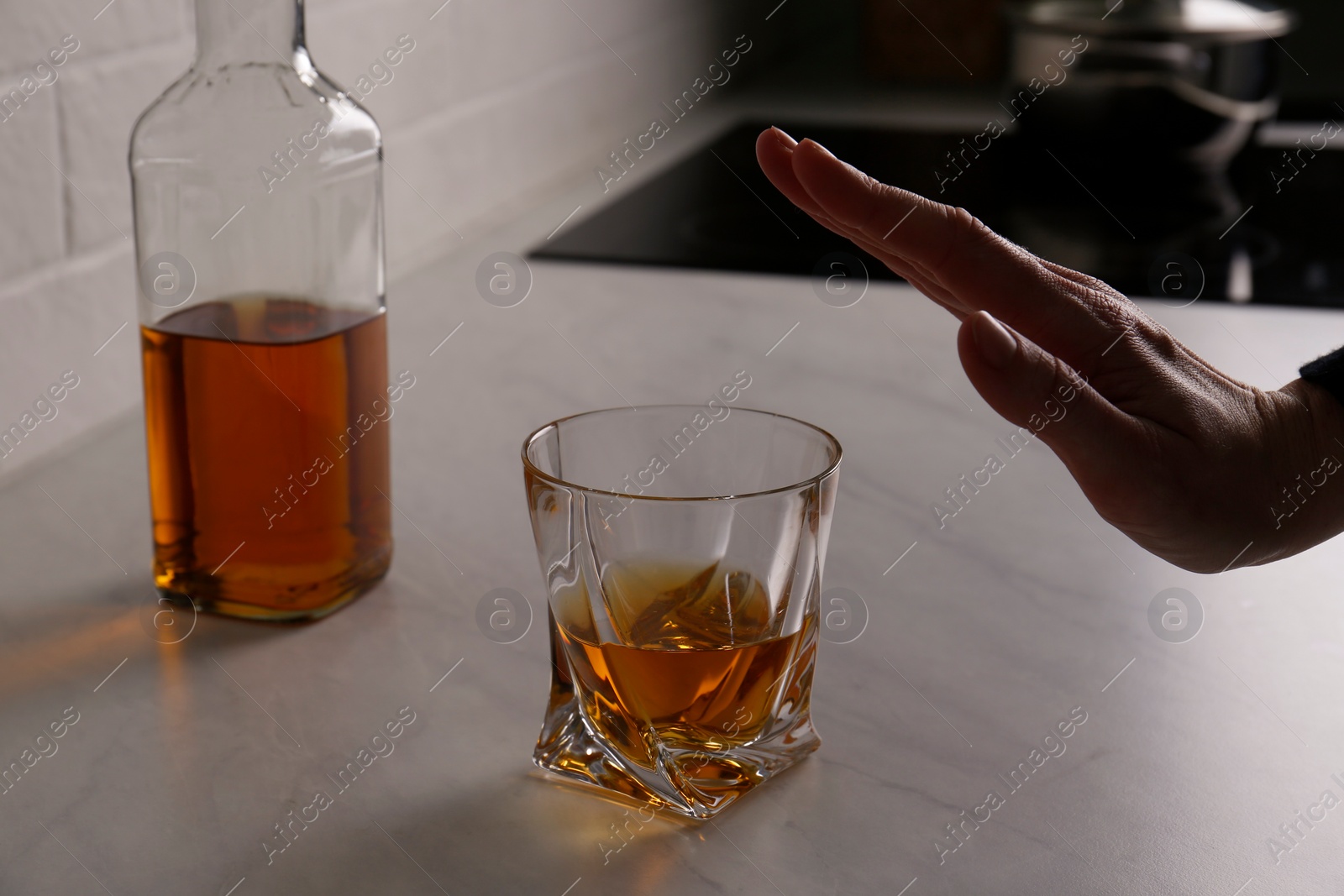 Photo of Woman refusing to drink whiskey indoors, closeup. Alcohol addiction treatment