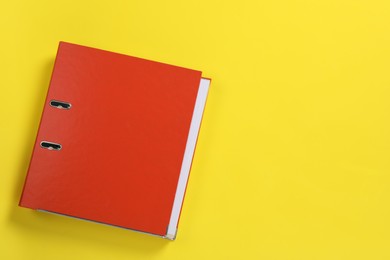Photo of Red office folder on yellow background, top view, Space for text