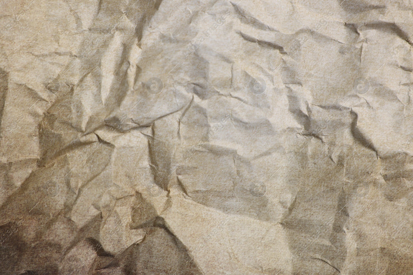 Photo of Texture of crumpled parchment paper as background, top view