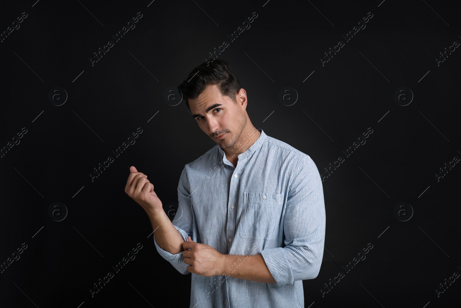 Photo of Portrait of handsome young man on black background