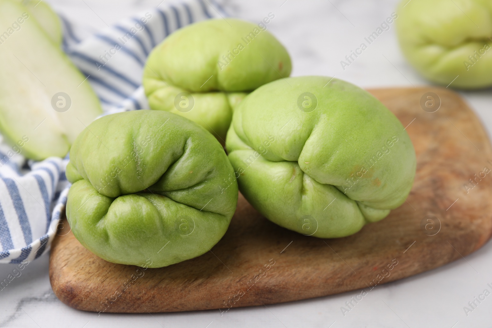 Photo of Fresh green chayote on light table, closeup