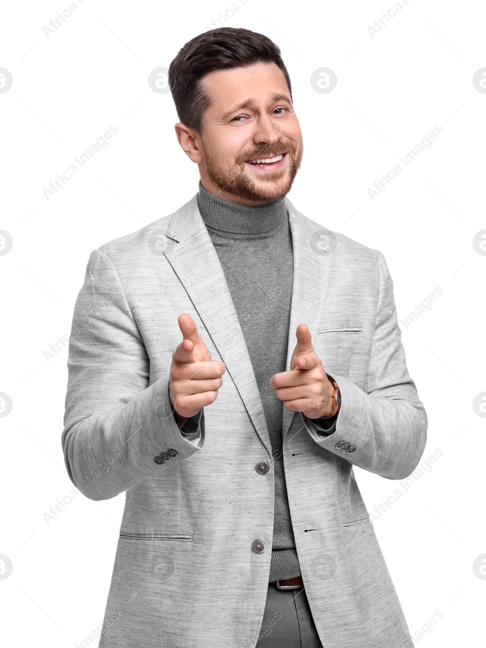 Photo of Handsome bearded businessman in suit pointing at something on white background