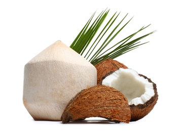 Photo of Fresh ripe coconuts with leaves on white background