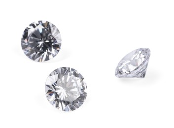 Photo of Three beautiful shiny diamonds isolated on white