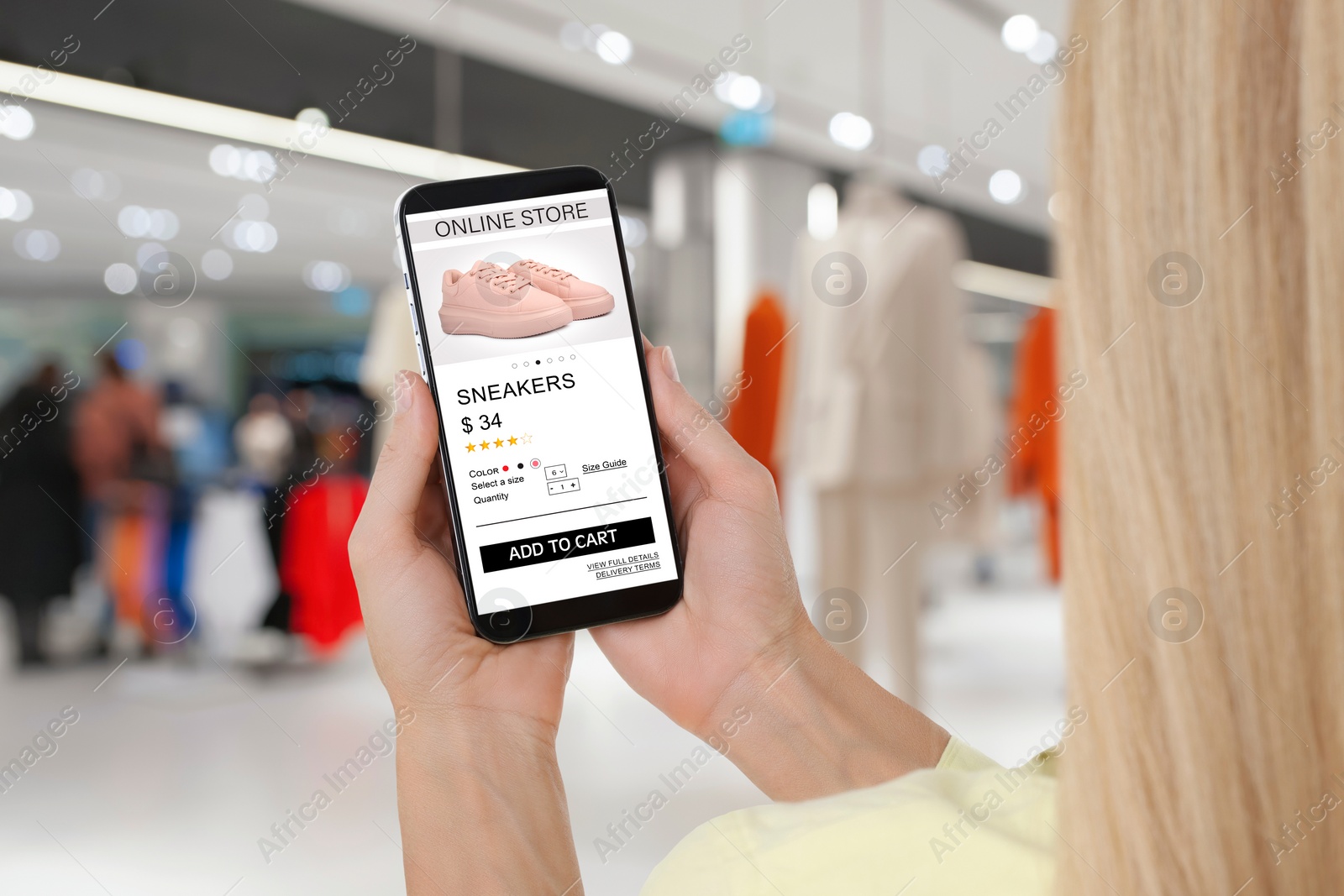 Image of Woman visiting shop to take ordered shoes indoors, closeup. Online store website on device screen