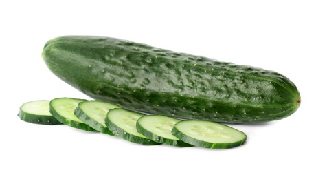 Photo of Whole and sliced fresh cucumbers on white background