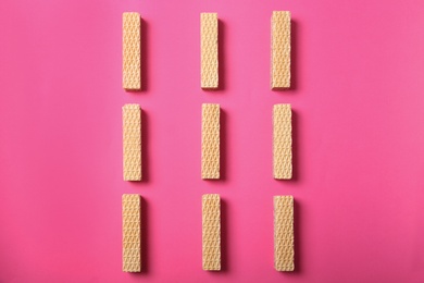 Photo of Flat lay composition with delicious crispy wafers on pink background